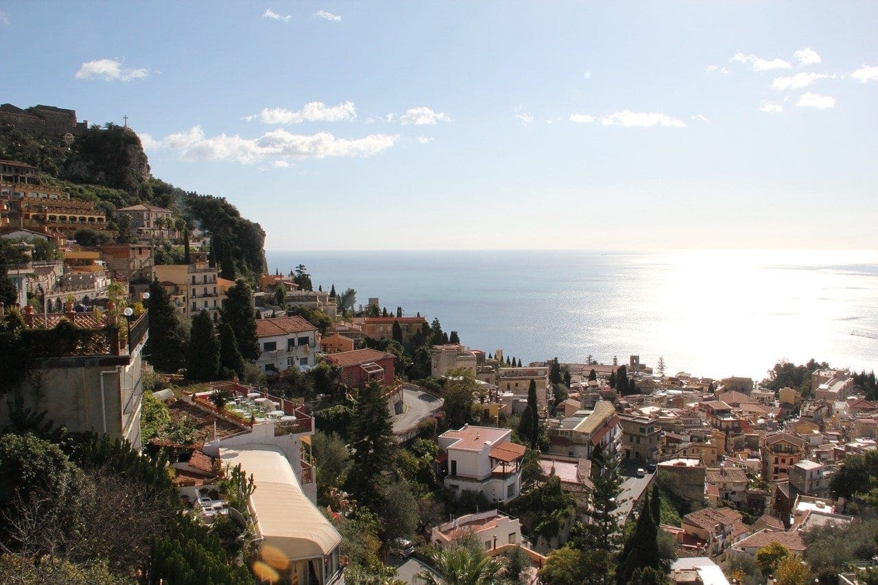 Sicilian coastal town with sailing boat