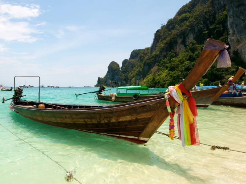 A picture of a long tail on a beach in Thailand