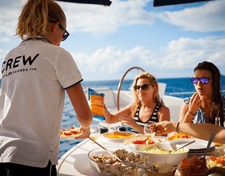 Crewed-Yacht-charter-greece-hostess-crew hostess serving drinks on a yacht charter