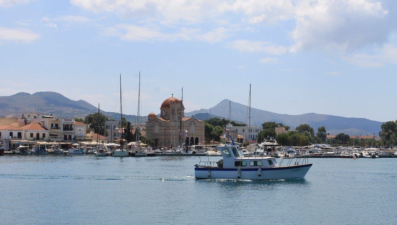 a marina and harbour with colorful houses greek sailing itineraries