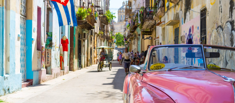 pink car and old houses in Cuba