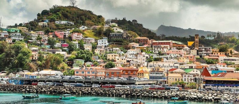 colorful houses and clear water on a Grenada sailing itinerary