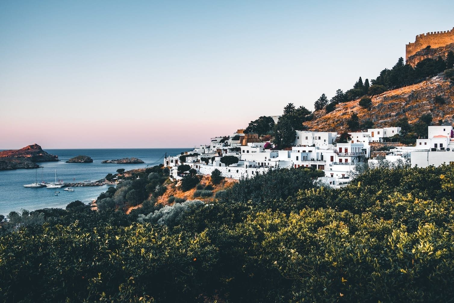 white houses in Rhodes next to the ocean