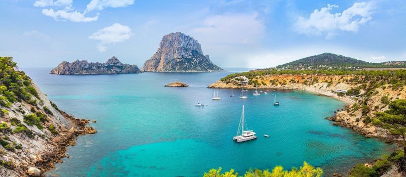 sailing boat and surrounding mountains on an ibiza sailing itinerary